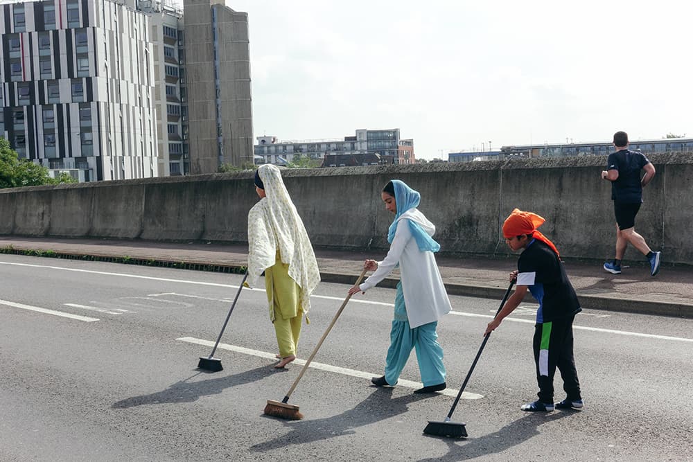 Sevadars leading a nagar kirtan procession through East London